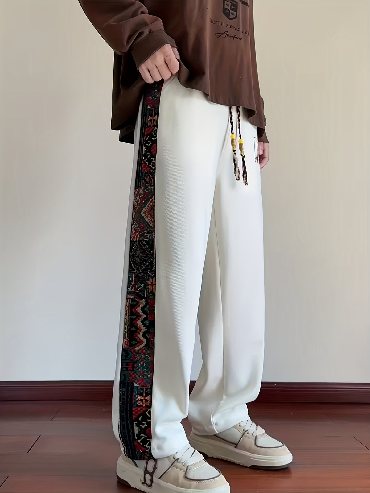 Men's Tribal Embroidery Printed Joggers with Elastic Drawstring Waist, Totem Embroidered Casual Pants Suitable for Autumn and Winter Seasons. Hand Wash Only, Non-stretch Fabric. Features Vintage Totem Side Stripes and Tassel Drawstring for a